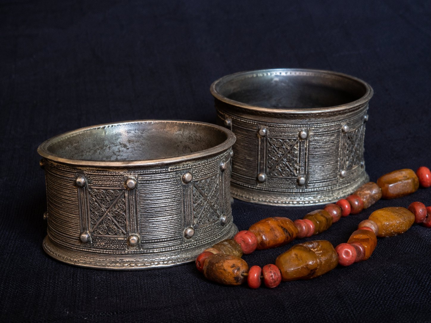 Nubian silver bangles with amber and coral beads
